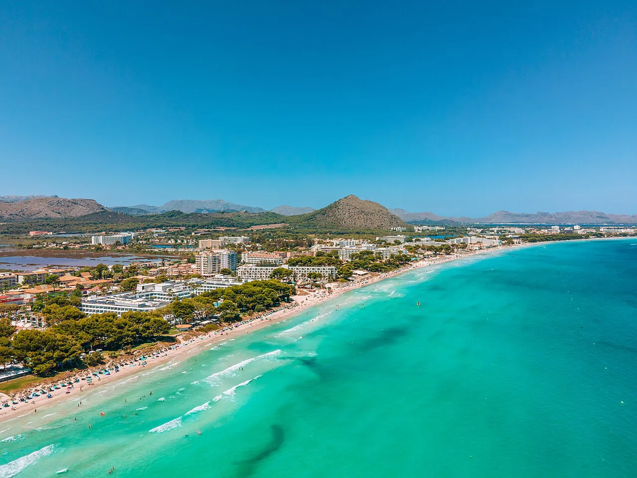 Aerial view of the long turquoise shoreline of Platja de Muro near Alcúdia, Mallorca