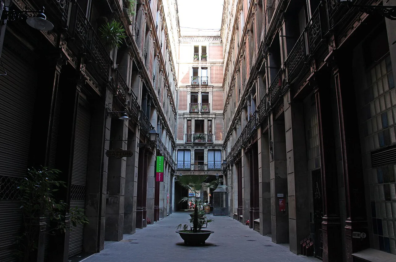 Narrow Passatge del Crèdit lined with tall stone buildings in the Gothic Quarter of Barcelona