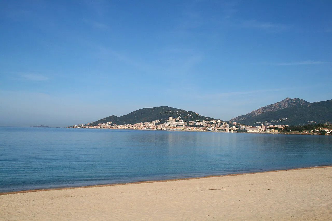 Sandy Ricanto beach on the Gulf of Ajaccio with the city and hills across the bay