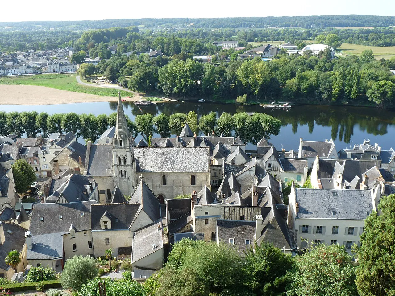 Slate rooftops and church spire of Chinon's old town beside the Vienne, seen from the royal fortress