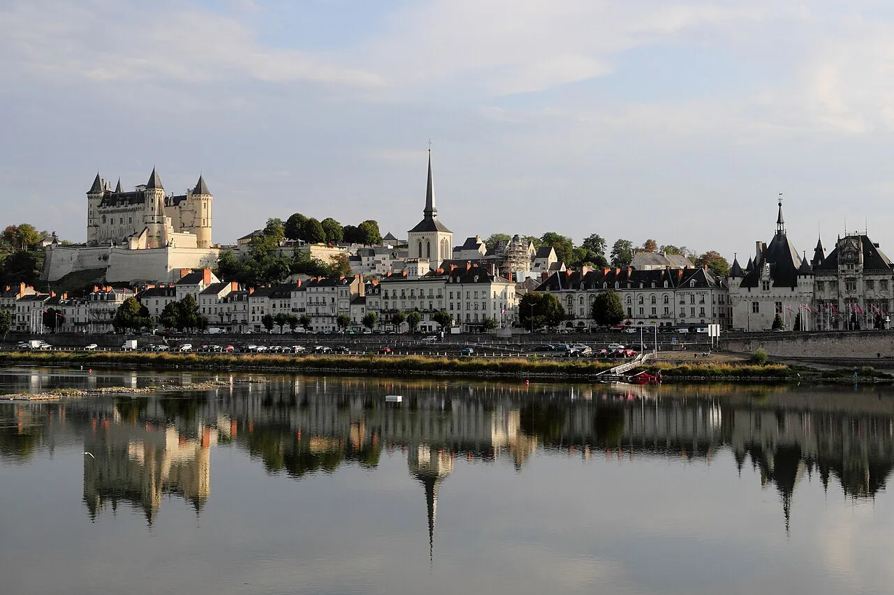 The Château de Saumur and the town's church spire reflected in the still Loire at Saumur