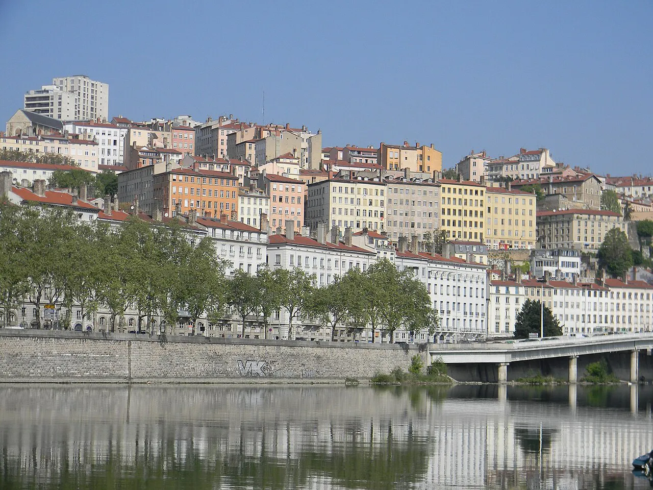 Croix-Rousse hillside buildings rising above the tree-lined banks of the Rhône in Lyon