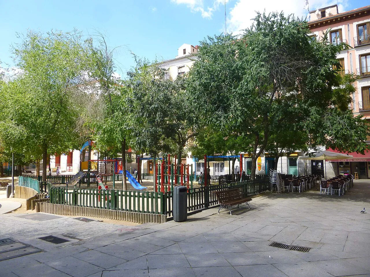 Leafy Plaza del Dos de Mayo with its brick arch in the Malasaña neighbourhood of Madrid