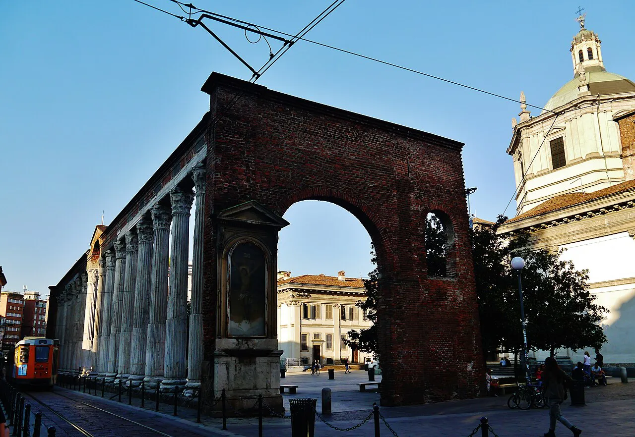 Roman Colonne di San Lorenzo and brick arch in Milan, with the dome of San Lorenzo basilica beside them