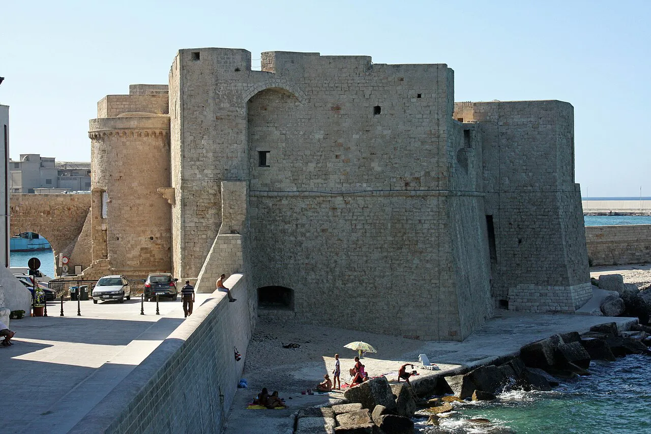 Stone bastions of the Castello di Carlo V beside the sea wall in Monopoli