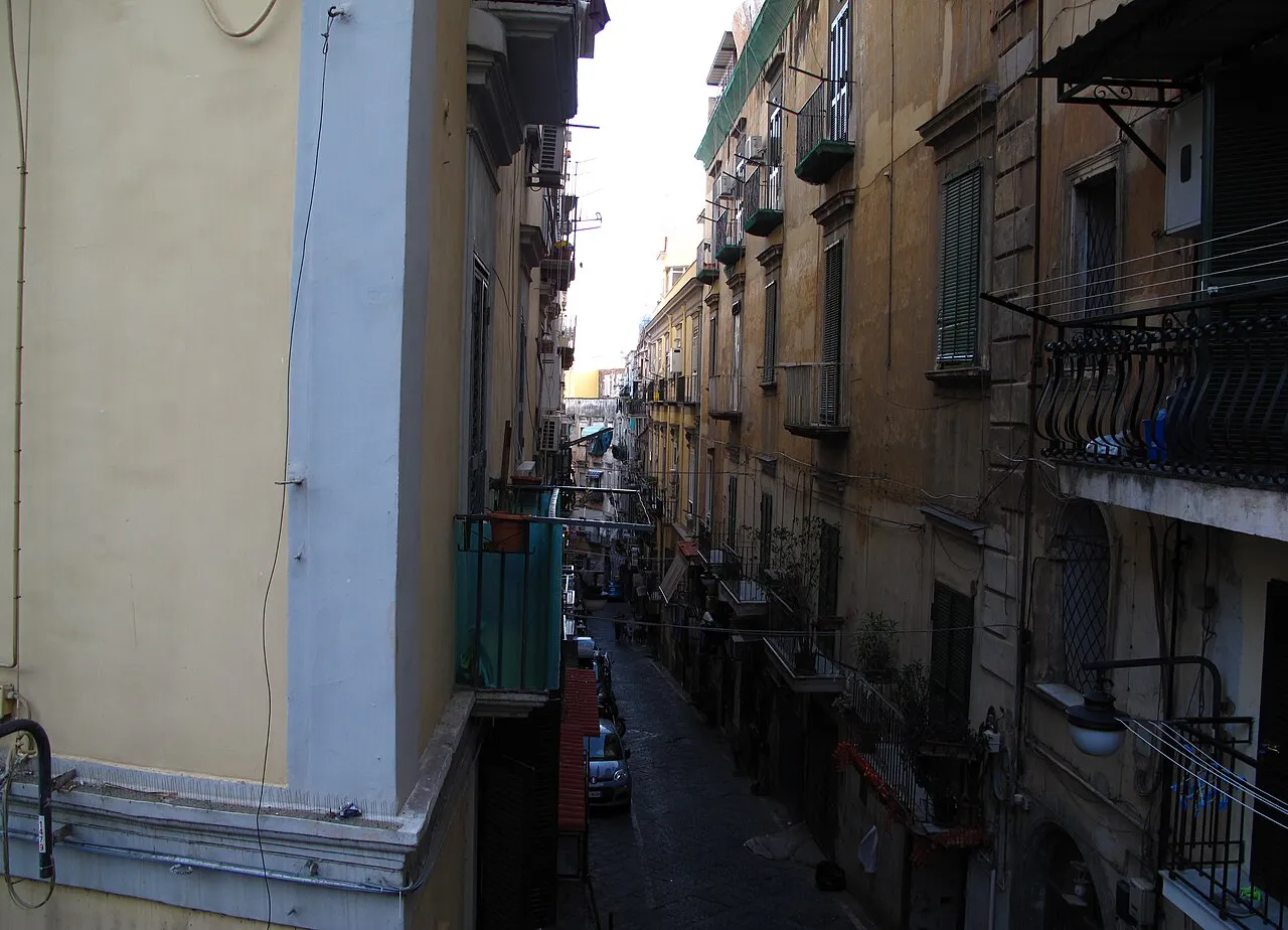 Narrow lane between tall residential buildings with balconies in the Quartieri Spagnoli, Naples
