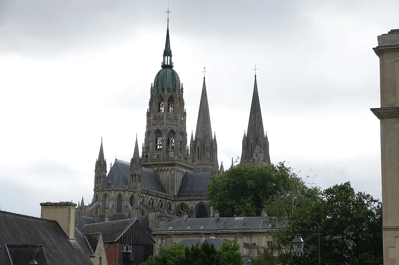 Spires and central tower of Bayeux Cathedral rising above the rooftops of Bayeux
