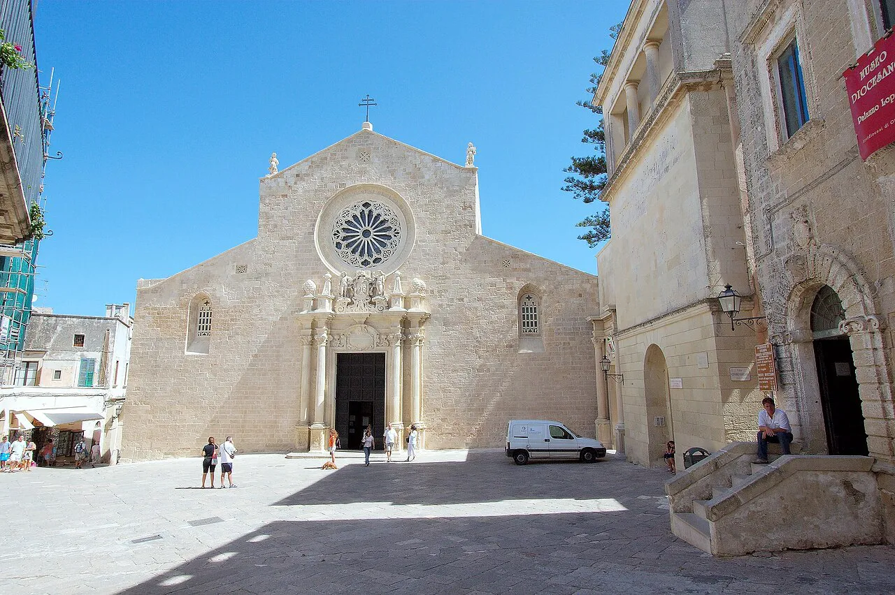 Romanesque facade and rose window of Otranto Cathedral on its sunny stone piazza