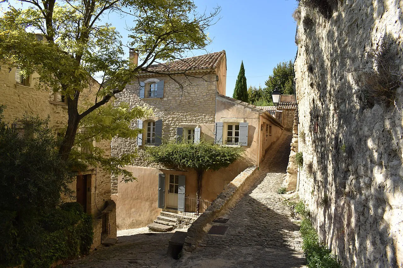 Sunlit stone lane and houses in the hill village of Gordes