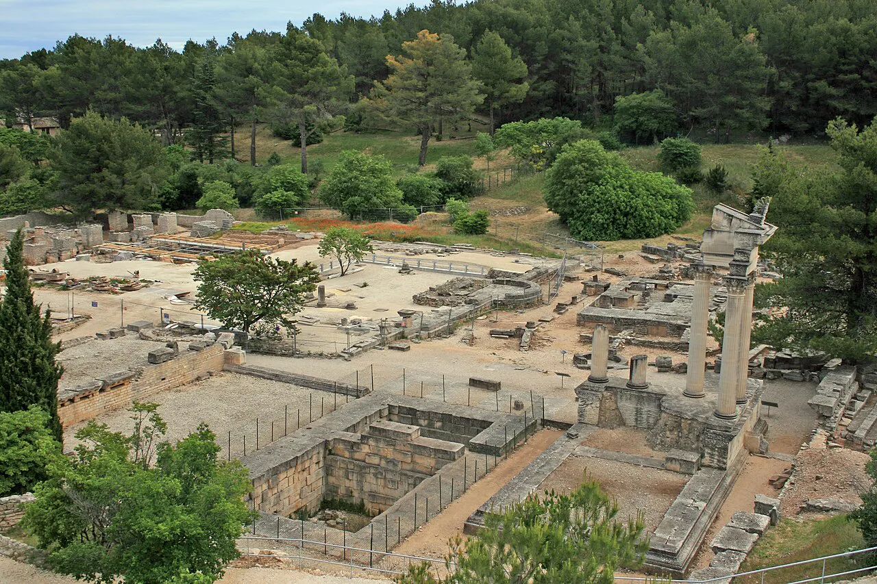 Excavated Roman ruins of Glanum below pine-covered hills at Saint-Rémy-de-Provence
