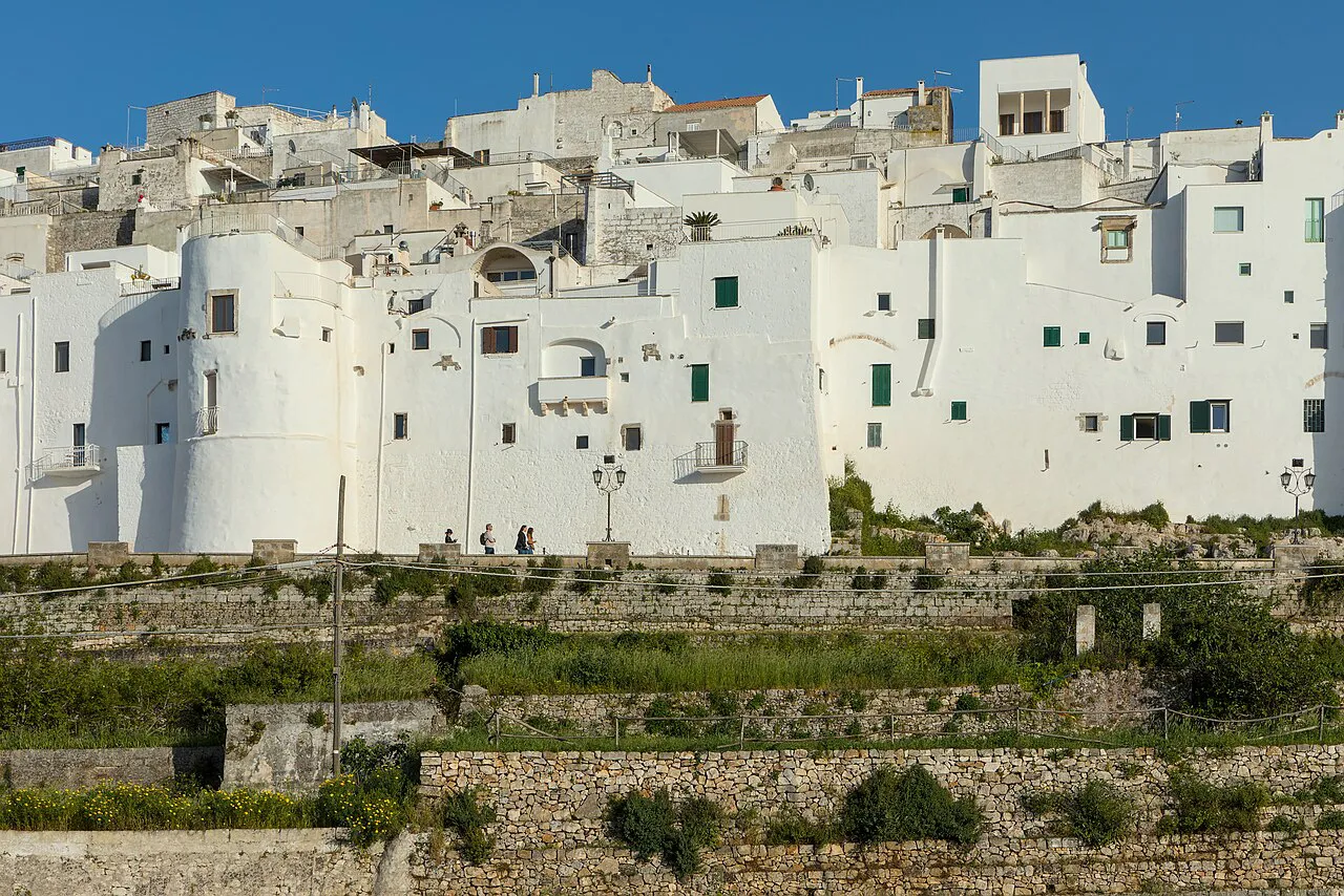 Whitewashed houses of Ostuni old town stacked above the city walls and terraced gardens