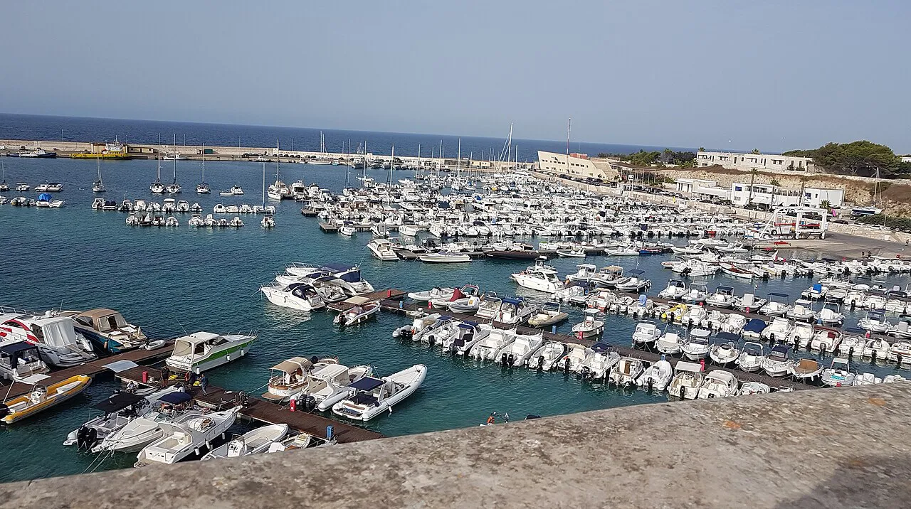 Small boats packed into the harbour at Otranto, seen from the old town walls
