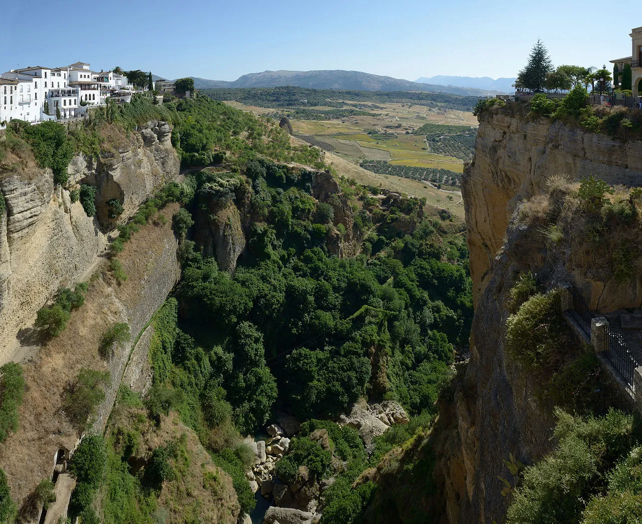El Tajo gorge in Ronda opening onto green farmland and hills beyond the town