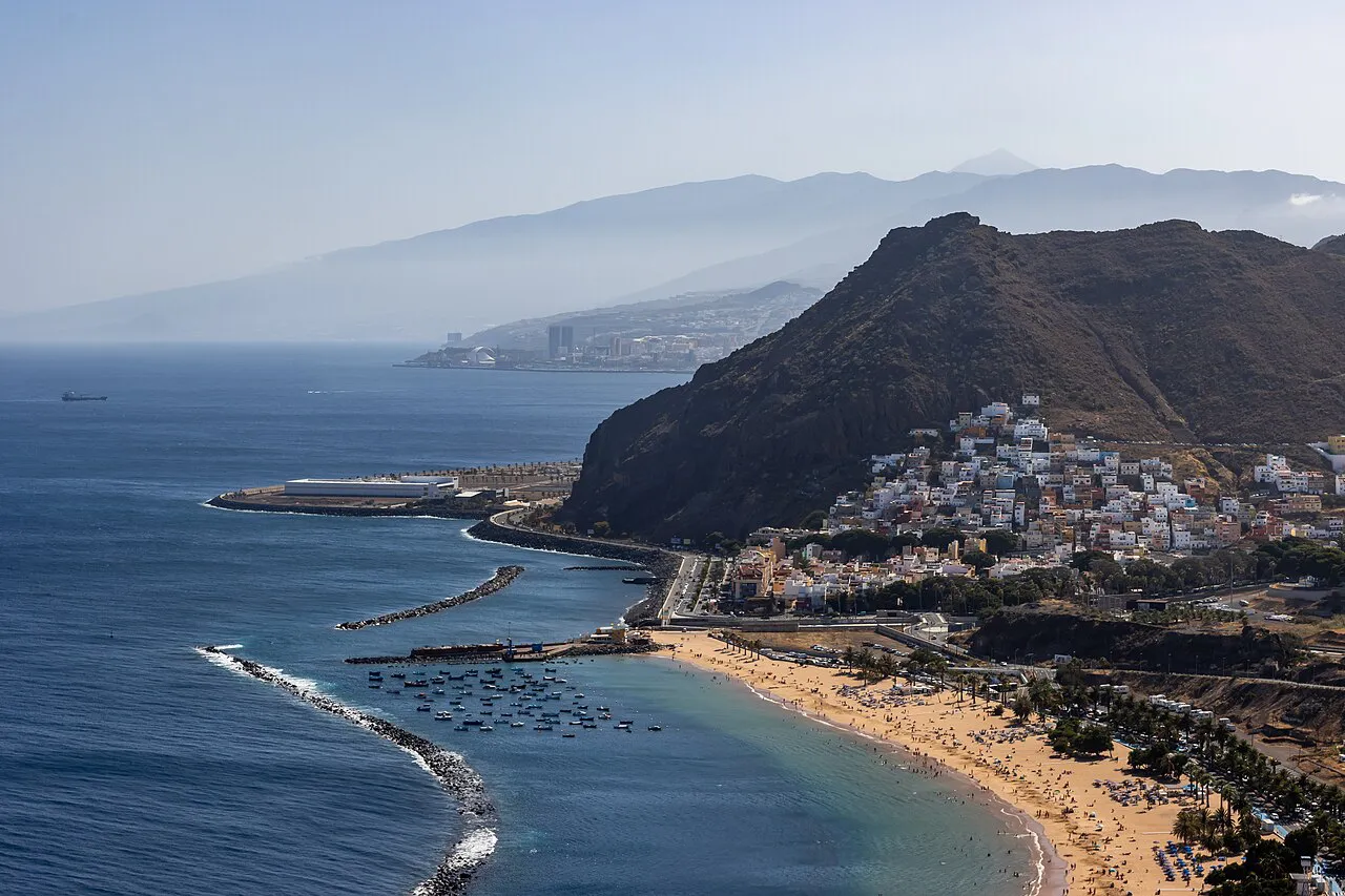 Golden sand of Playa de Las Teresitas and the village of San Andrés below a rocky ridge, seen from a viewpoint