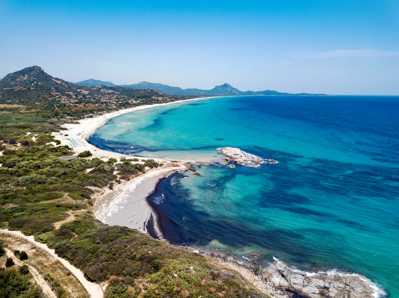 Aerial view of the white-sand curve and turquoise water of Costa Rei on Sardinia's southeast coast