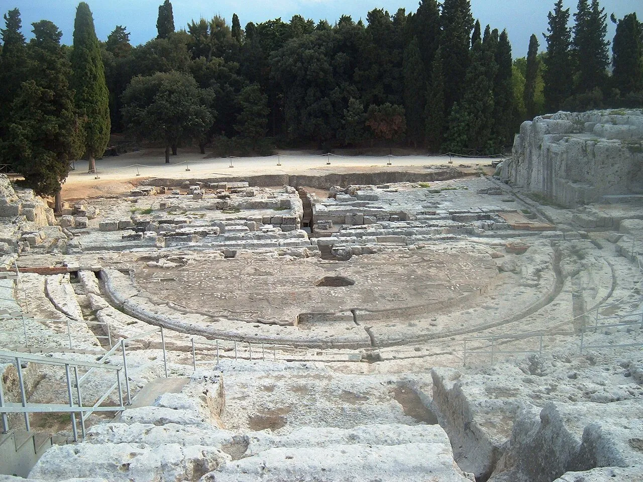 Stone seating of the ancient Greek theatre in Siracusa’s Neapolis park, cut into the hillside