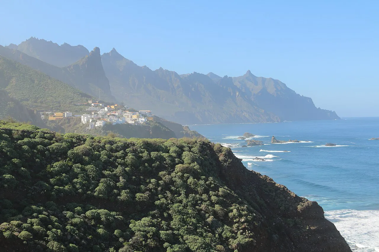 Steep green ridges of the Anaga Mountains above a coastal hamlet and the Atlantic, Tenerife