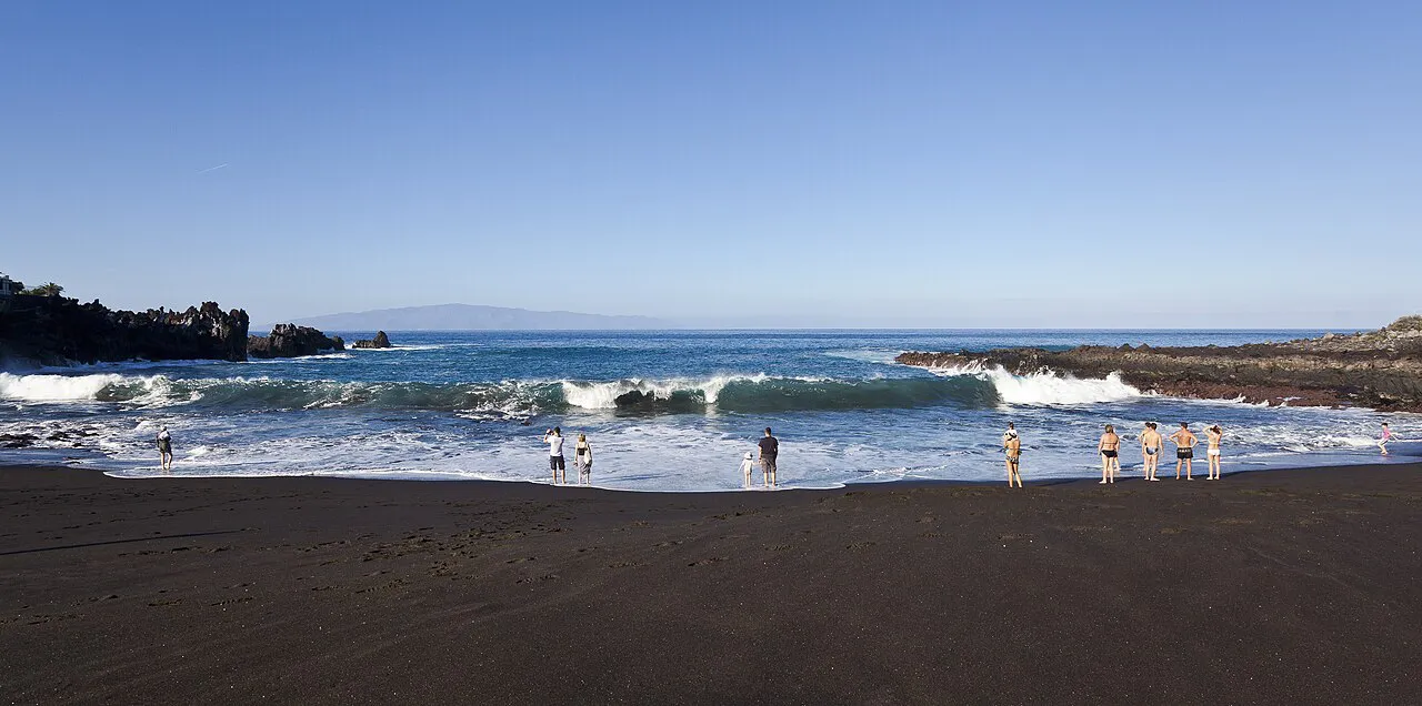 Atlantic waves rolling onto the black volcanic sand of Playa de la Arena in Puerto de Santiago, Tenerife