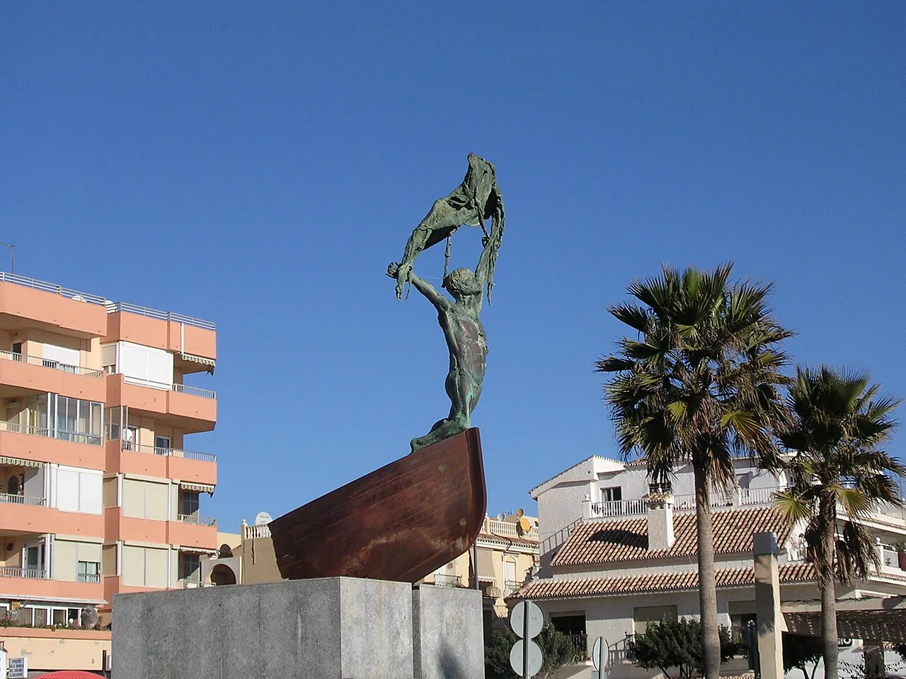 The Monumento al Pescador fisherman sculpture on a boat-shaped plinth on the La Carihuela promenade
