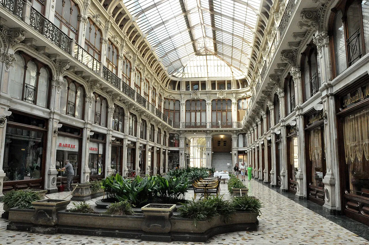 Glass-roofed Galleria Subalpina in Turin, an ornate 19th-century arcade with planters along its floor