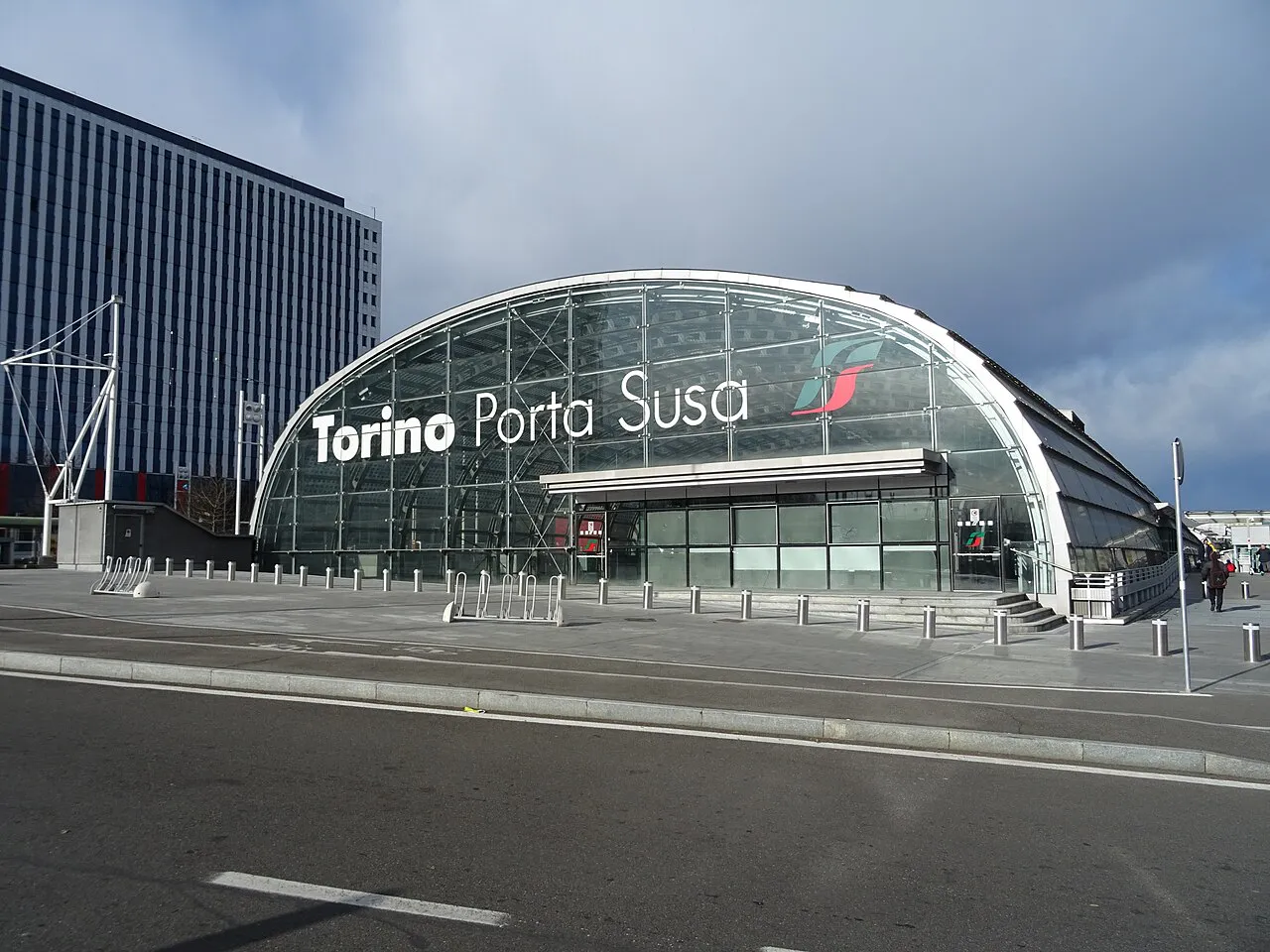 Curved glass and steel entrance of Torino Porta Susa railway station