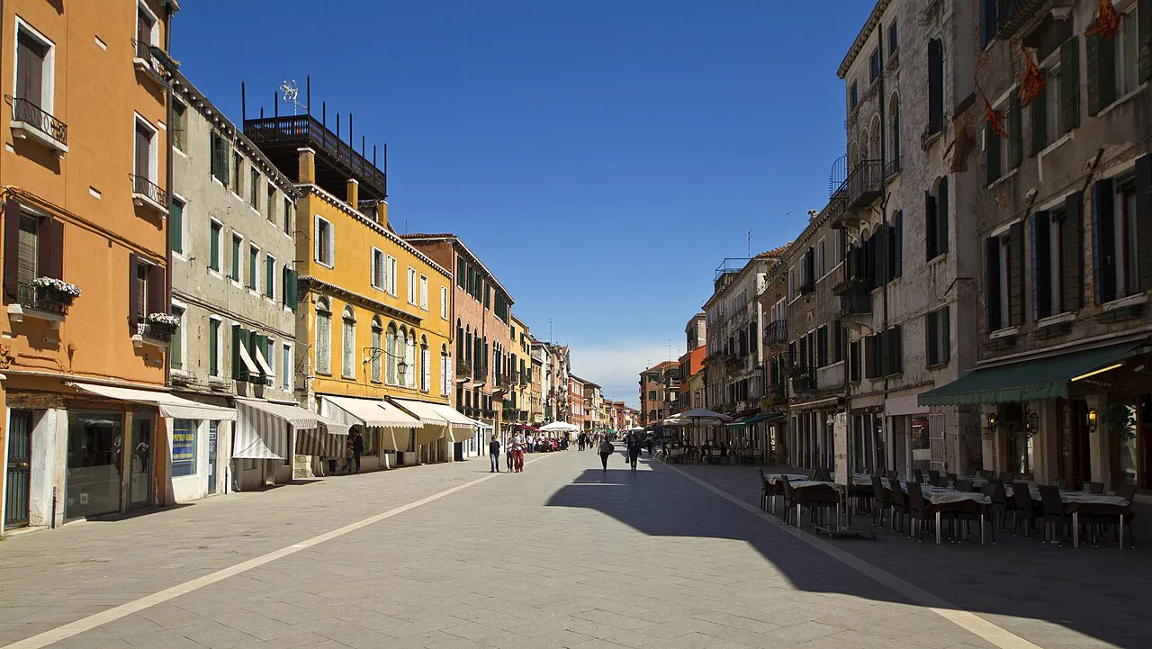 Wide paved Via Garibaldi in the Castello district of Venice, lined with colourful houses